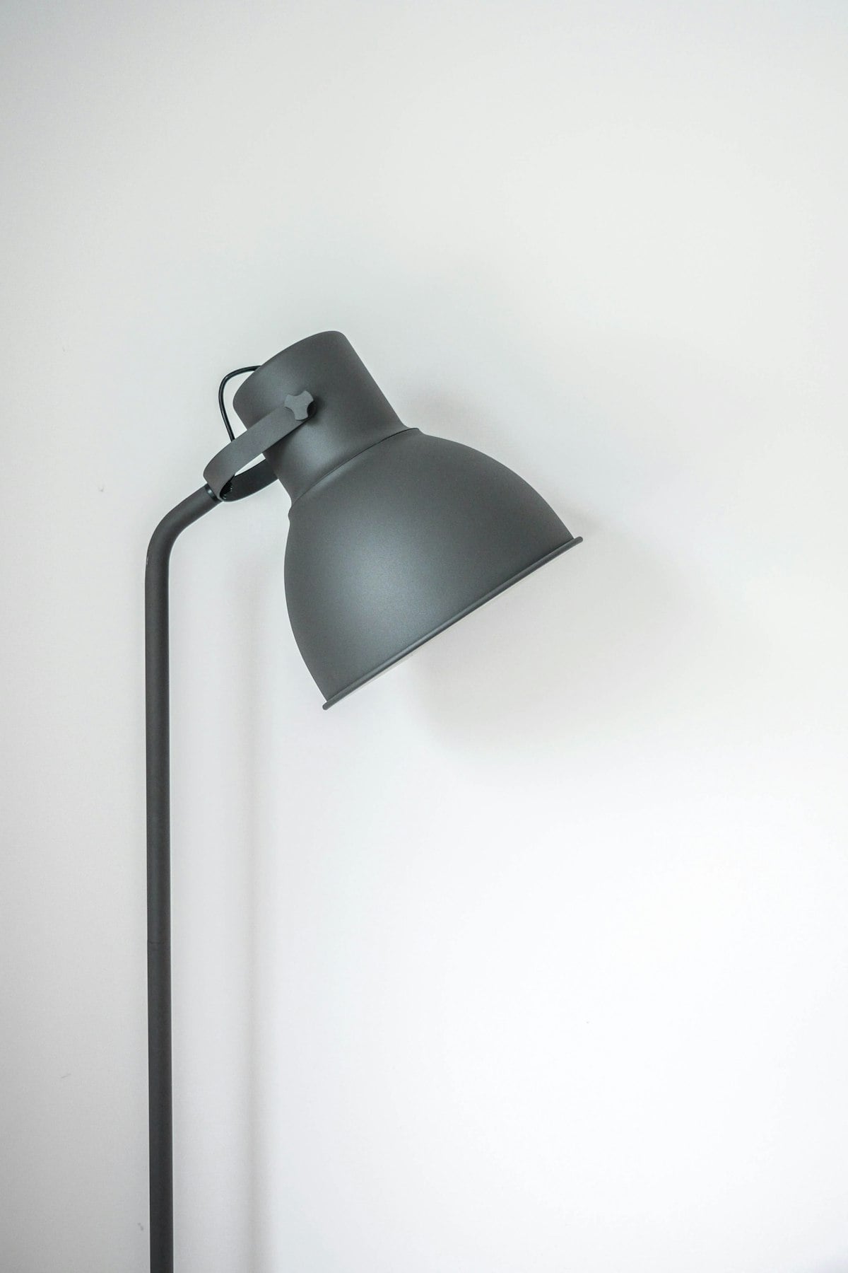 Warm ambient glow from sculptural ceramic smart lamp casting soft amber light across wood room